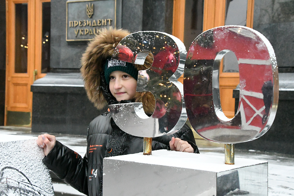 『30』はロシアからの独立30周年。女の子は父親から写真を撮ってもらっていた。＝30日、キエフ　撮影：田中龍作＝